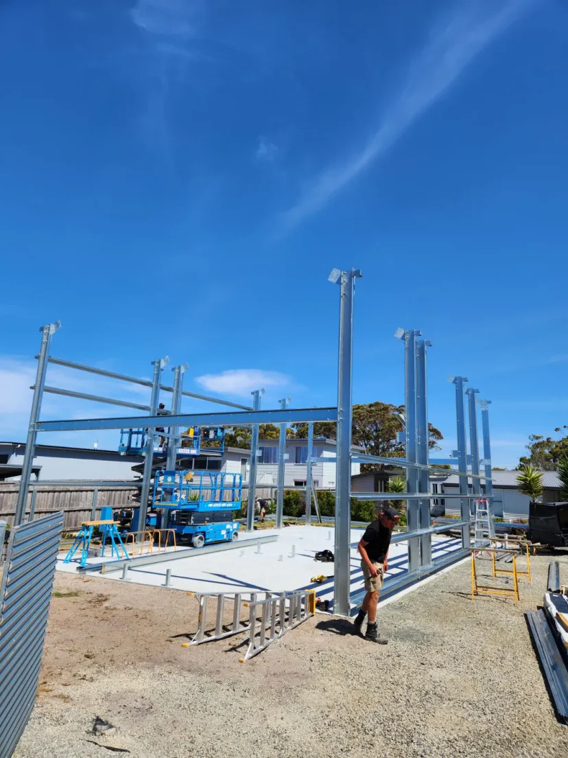 Steel columns standing on the concrete slab, day one of the Shed Home 03 build at Weymouth
